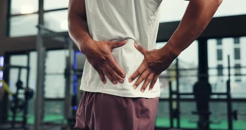 Hands, fitness and hip of man in gym with pain, discomfort and injury for workout