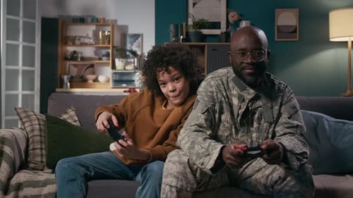 Father and Child Playing Video Games at Home