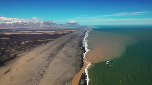 Aerial View Of River Mouth On The Beach In South Iceland Coast - aerial pullback