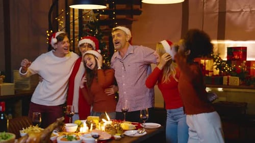 Friends and Family Singing at Christmas Dinner