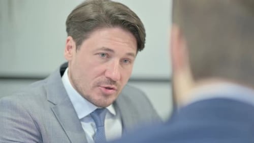 Close Up of Businessman Talking with Partner in Office