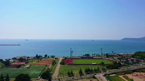 Approaching the beautiful waterscape of Adriatic Sea. Drone footage above the green area