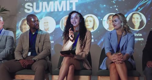 Business Professionals Speaking on a Panel at a Summit