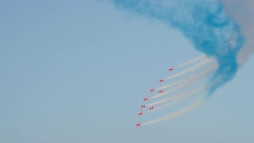 Aerobatic Airplanes Flying in Formation Leaving Colored Smoke Trails