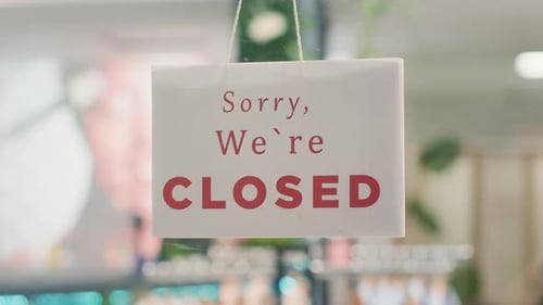Closed Sign on Clothing Store Door