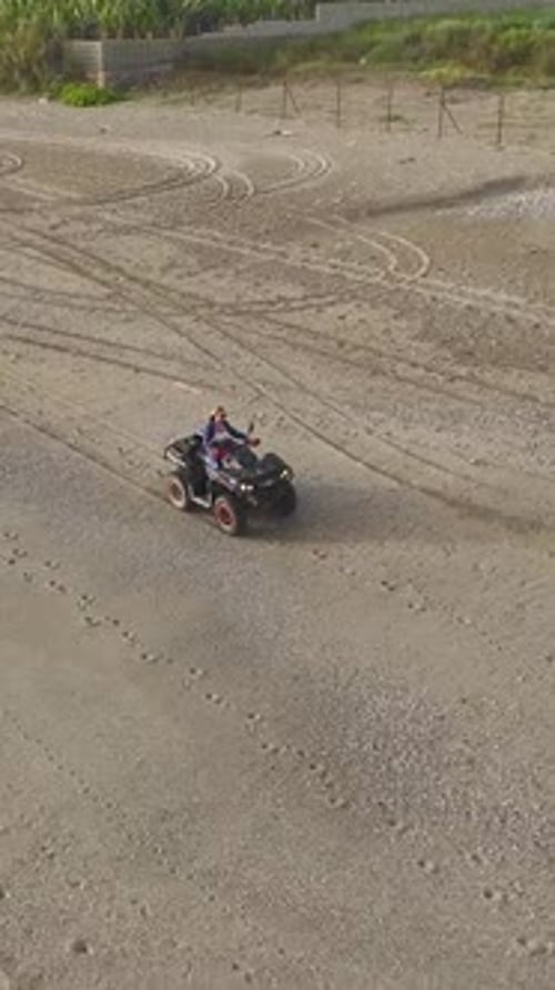 Vertical Video Glamorous Model Rides a Quad Bike With the Mediterranean Sunset As a Backdrop