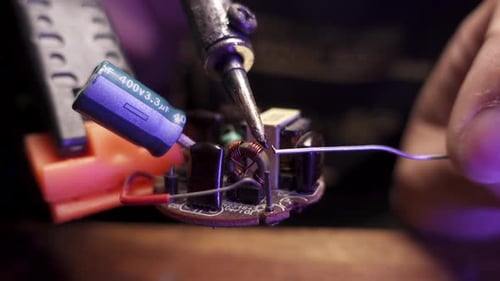 Soldering Iron Connecting Wires on Circuit Board