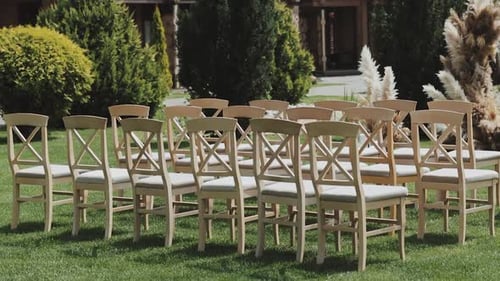 Wedding Ceremony Chairs Arranged on Green Grass