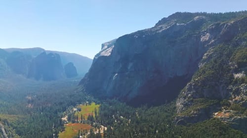 Bright sun lighting the beautiful valley among the huge mountains. Stunning scenery