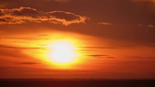 Beautiful sunset over the forest in the rays of the setting sun, time lapse