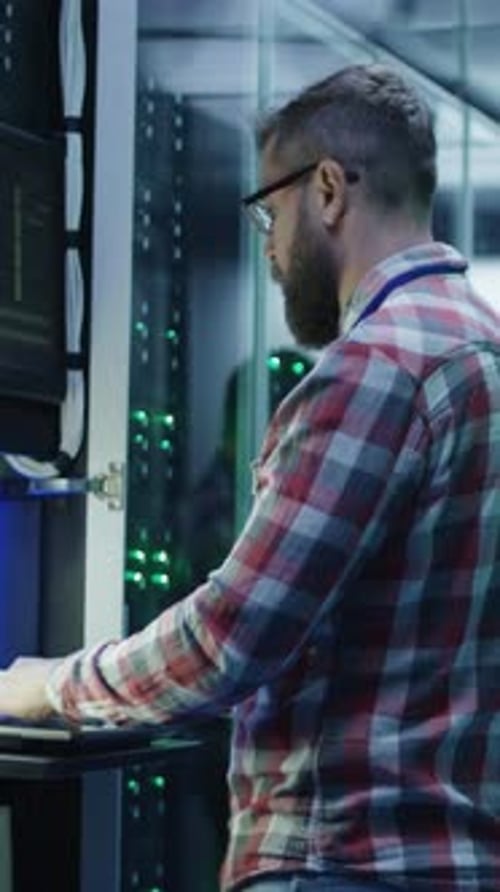 Bearded IT Specialist Setting Servers in Data Center