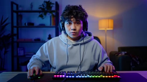 Young Adult Gaming with Colorful Keyboard