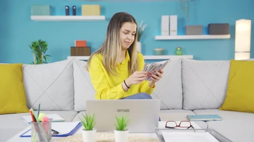 Woman Works and Counts Money at Home