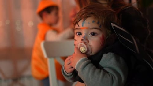 Mother and Toddler in Costume Celebrate with Family