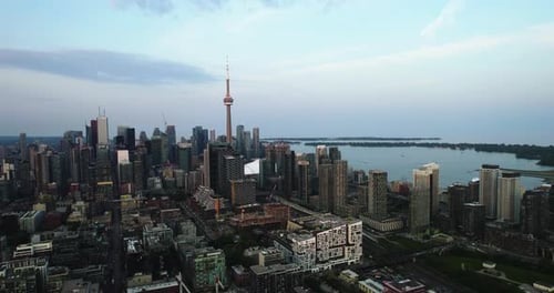 Flying away from downtown Toronto, sunset in Canada - pull back, drone shot