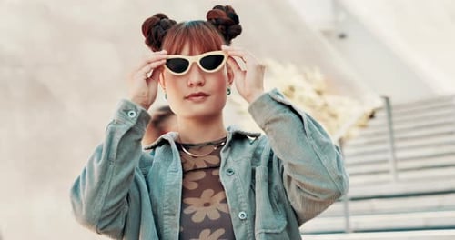 Face, fashion and woman with sunglasses in city, style and trendy clothes outdoor in urban town