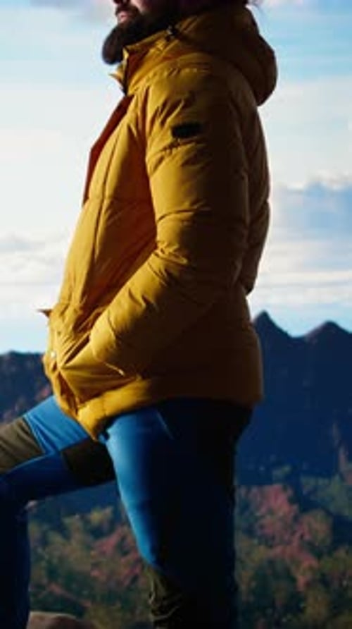 Vertical Video Hiker Gazes at the Panoramic View of Dramatic Mountain Peaks and Clouds