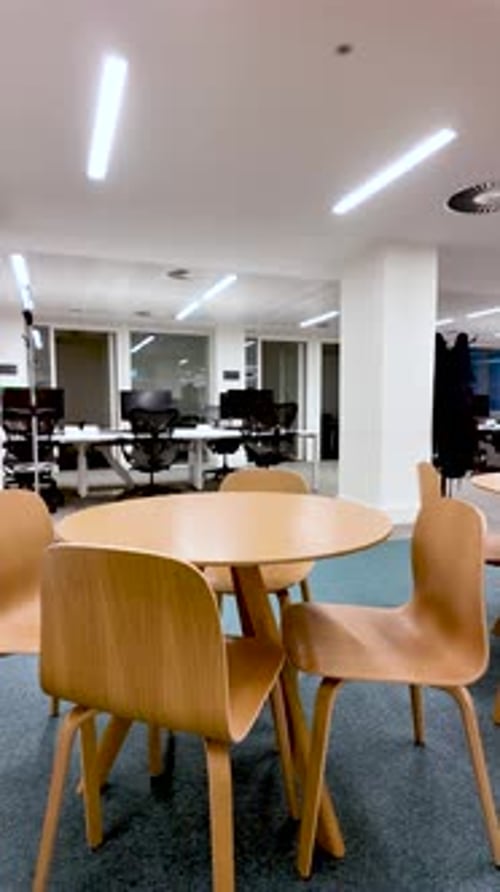 Empty Wooden Table And Chairs In Modern Office Space With Desks And Computers Ideal For Workplace