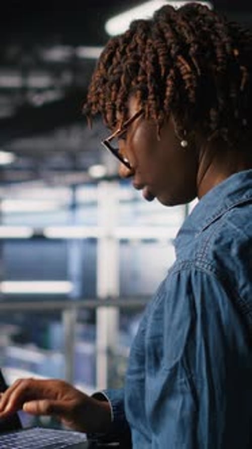 Vertical Video Technician in Data Center Stressed By Critical Error Popup on Laptop