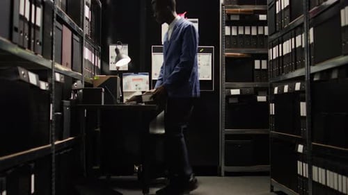 Man Working at Desk with Files in Urban Office