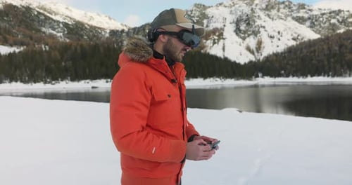 Drone pilot with FPV viewer controlling DJI Avata quadcopter with wireless remote control surrounded