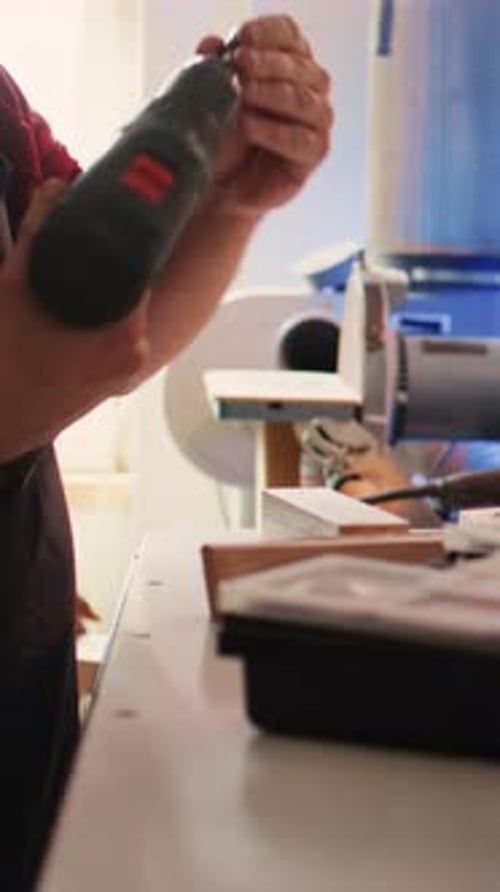 Vertical Video Manufacturer in Assembly Shop Picking Screw From Tool Box