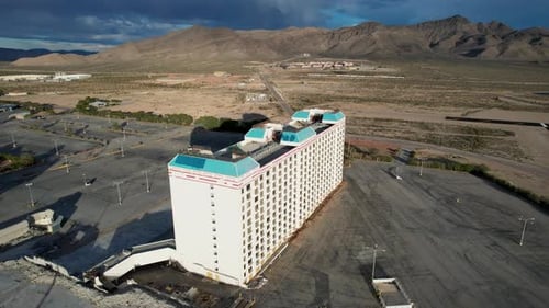 Shut down Nevada Casino hotel with empty parking lot awaiting demolition- aerial view on cloudy day