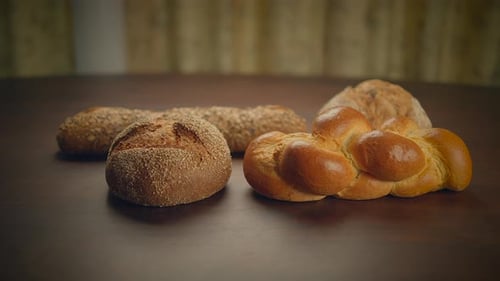 Variety of Fresh Breads on a Wooden Table