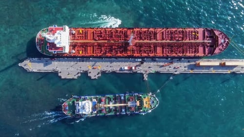A Stunning Aerial View Showcasing Numerous Cargo Vessels Docked at the Bustling Port Facility