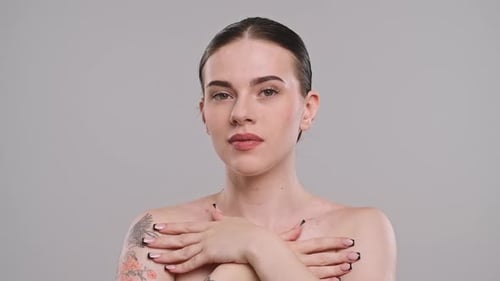 Young Adult Woman Posing with Hands and Tattoo
