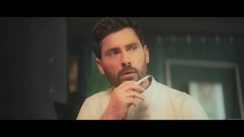 Pensive Man with Pen Thinking Indoors