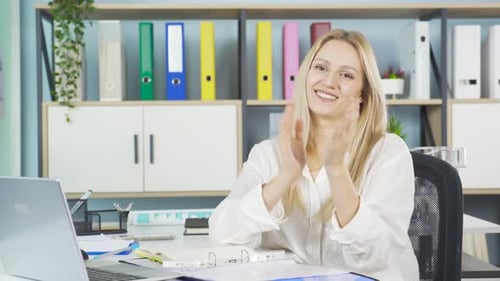 Woman in Office Applauding with a Smile