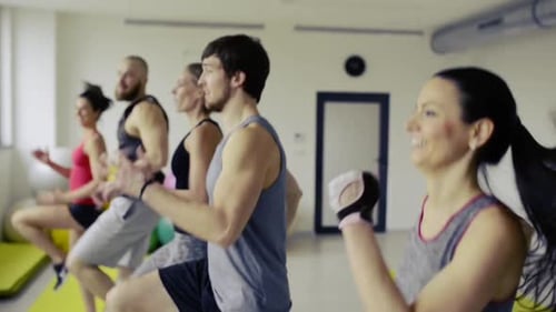 Young People in Crossfit Gym Doing High Knee Skipping