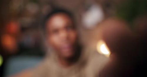 Content Creator This African Man Takes a Moment to Wipe the Camera Lens Before Settling Down on