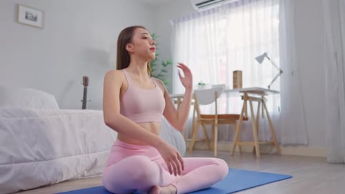 Woman Stretching Neck at Home on Yoga Mat