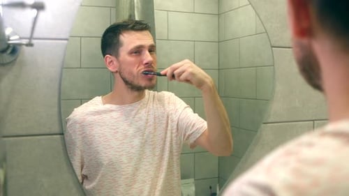 Handsome Man Brushing His Teeth
