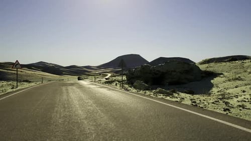 Cinematic POV Shot of Driving Through Arid Desert Terrain