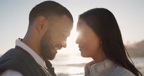 Forehead, beach and couple with love, smile and lens flare with commitment, happiness and romantic