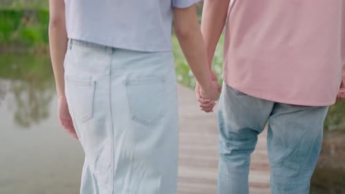 Cinematic video of a couple holding hands in a garden and doing various activities. Romantic concept