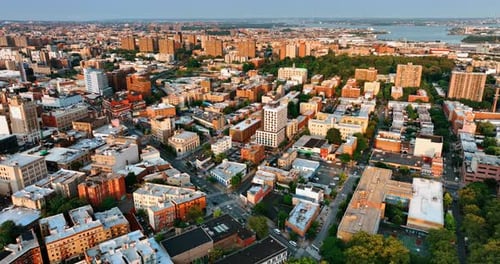 Facades of New York buildings lit with the rays of setting sun. Metropolis cityscape at sunset.