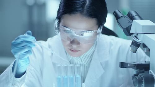 Female Scientist Working in Brightly Lit Lab