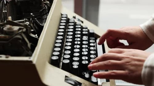 Male Hands Type On Keyboard Of Old Manual Typewriter. side view, slow motion