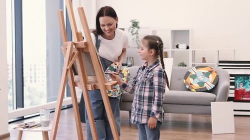 Art Person Teaching Little Child to Mix Paints on Paper