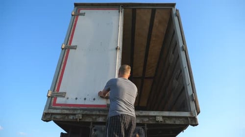 Man Opens Cargo Trailer Doors for Delivery