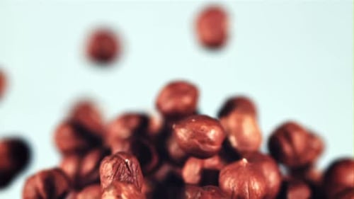 Peeled Hazelnuts Rise Up and Rotate in Flight