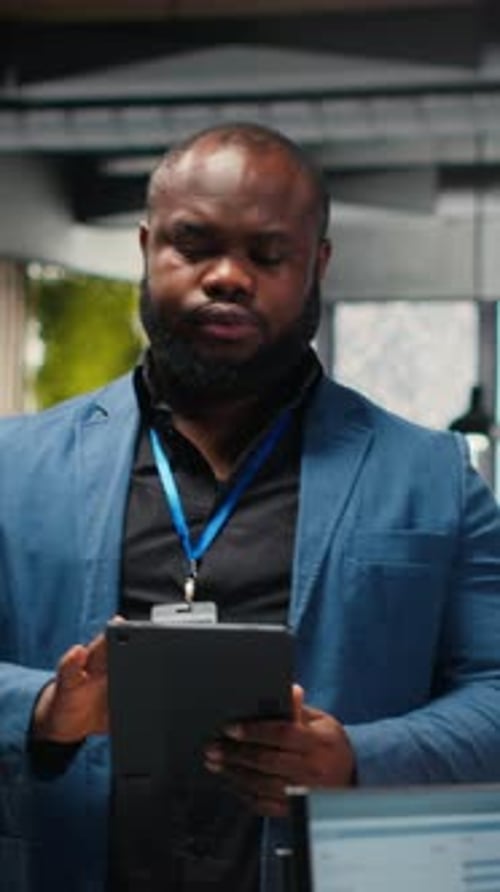 Adult Using Tablet in Modern Office Environment