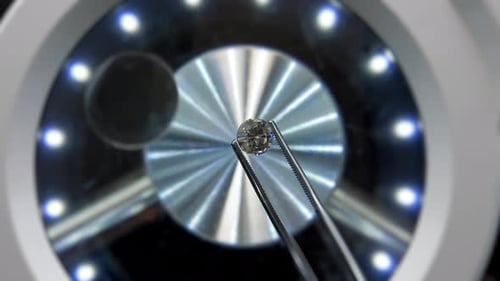 Close Up of Diamond Held by Tweezers