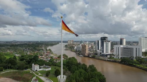 Aerial View of a Cityscape with River and Flag
