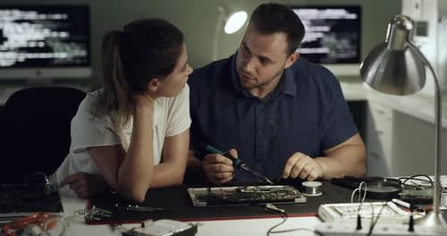 4K-Videomaterial von zwei jungen Technikern, die Computerhardware reparieren