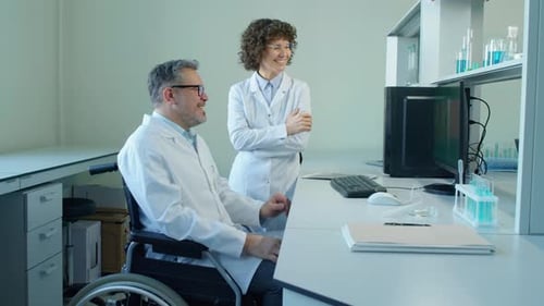 Scientists Collaborating in Bright Modern Laboratory